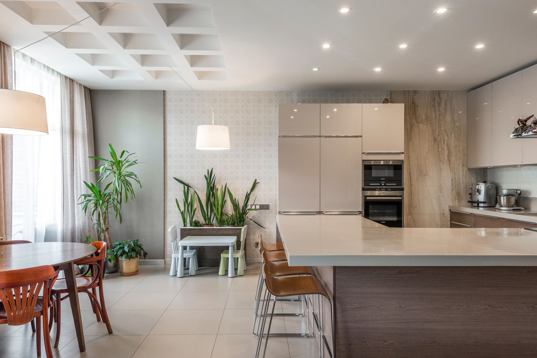 Spacious kitchen with elegant furnishings and greenery, perfect for modern living in Palm Springs, CA
